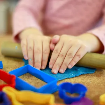 Cocoon Childcare Girl playing with Play Doh